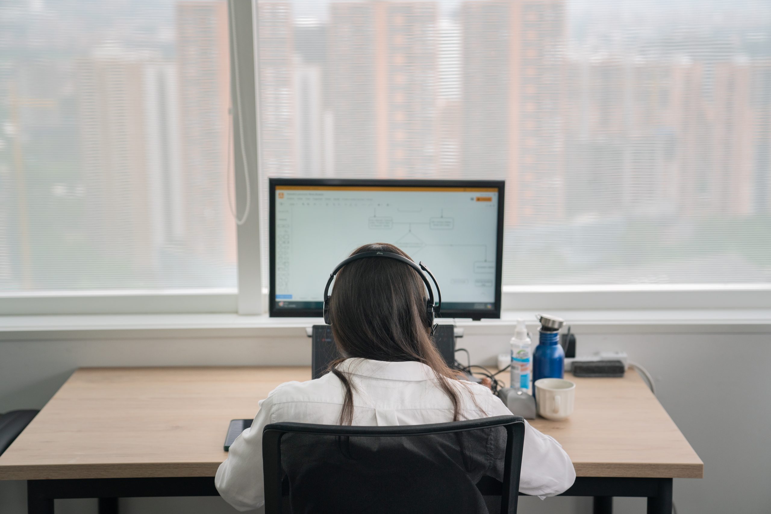 A colleague working at the Entirety Medellín office, engaged in research and analysis, representing our structured approach to regulatory intelligence.